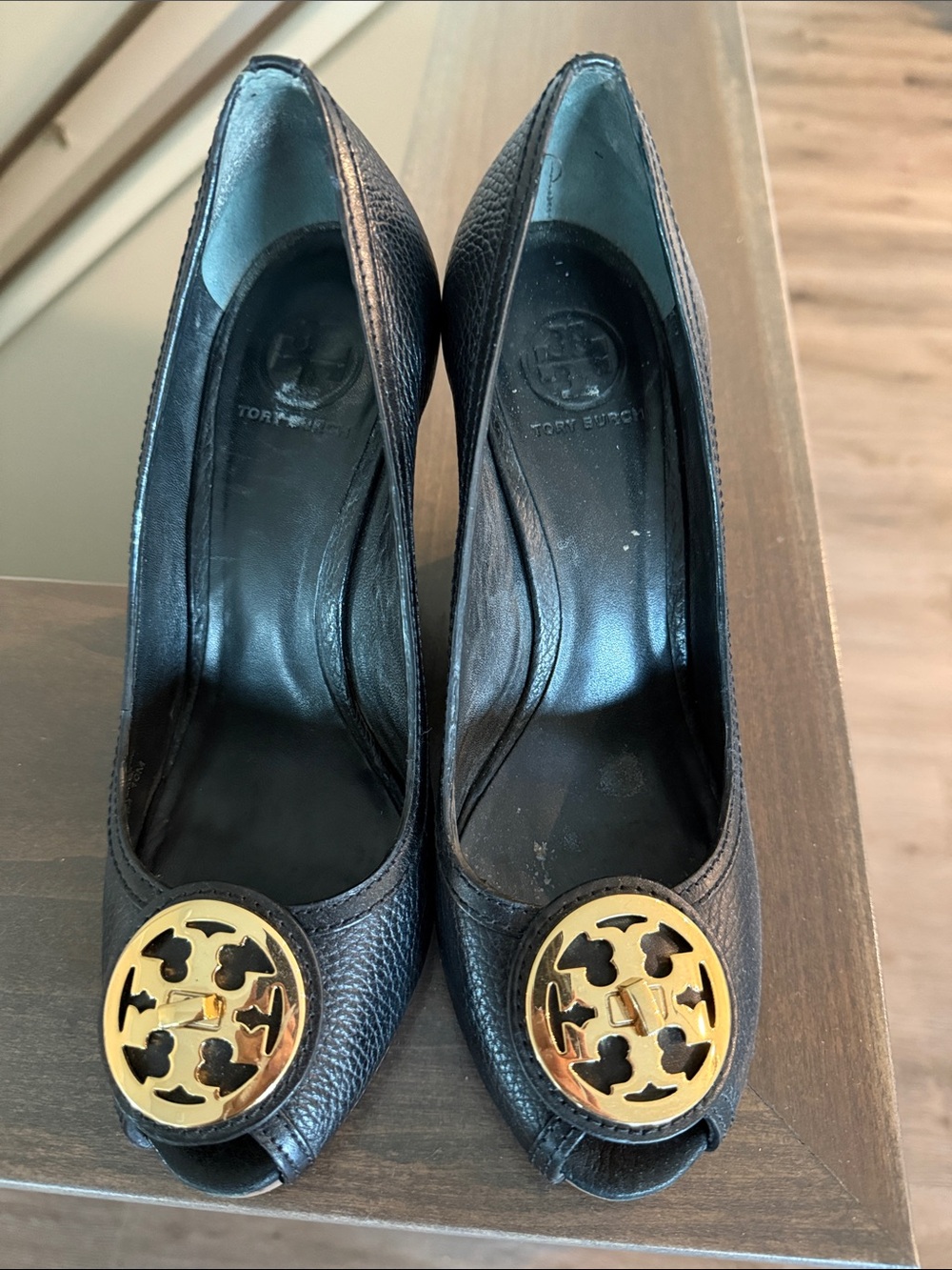 Tory Burch Black Pebbled Leather Peep-Toe Pumps with Gold Logo Medallion